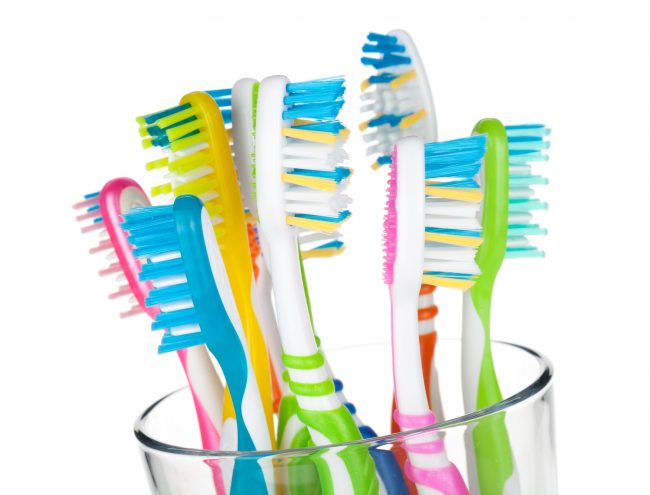 Colorful toothbrushes in glass